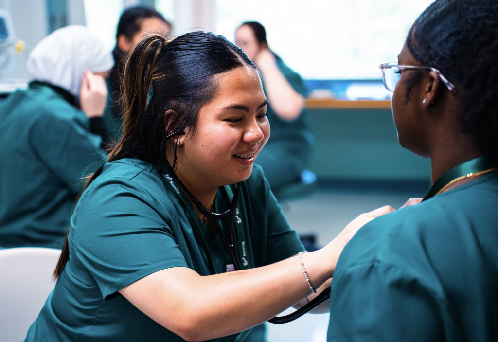 high school students practicing listening to heartbeats