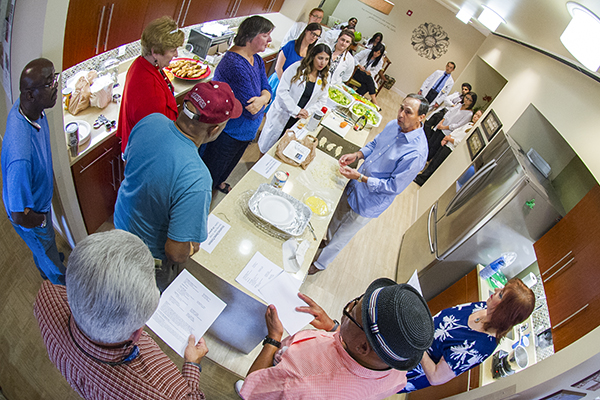 Diabetes patients watch a cooking demonstration as part of the nutrition section of the group education program.