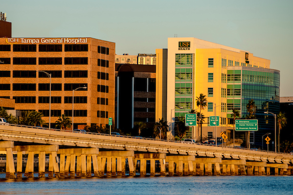 Pictured the exteriors Tampa General Hospital and USF Health South Tampa Center for Advanced Healthcare at sunset.